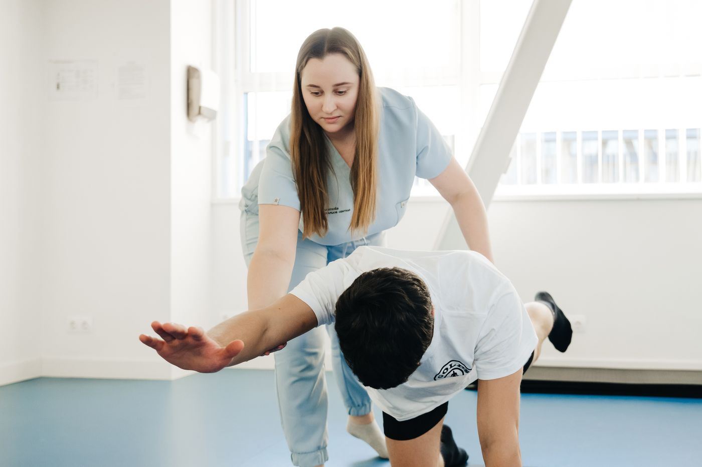 Fisioterapeuta guiando a un paciente en un ejercicio